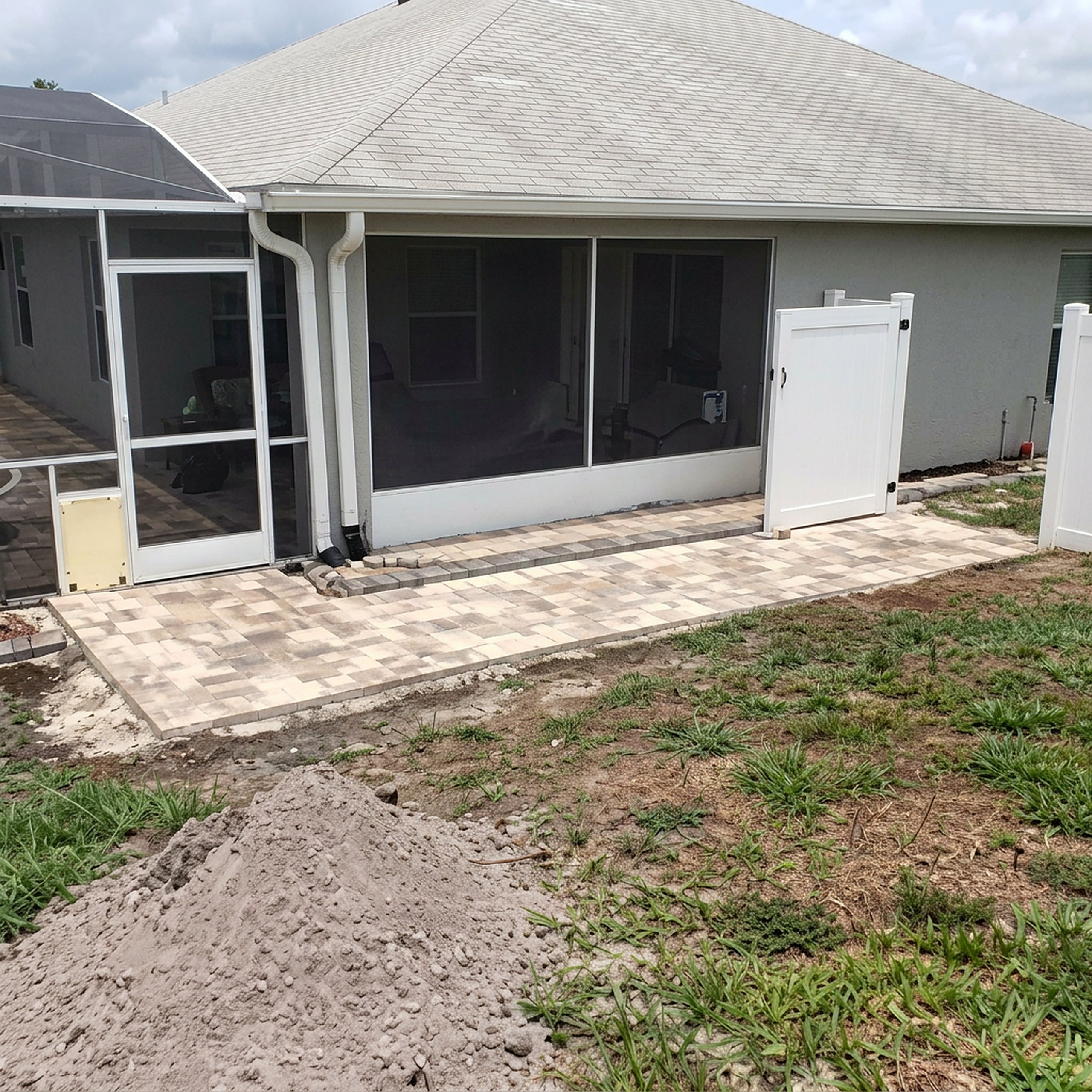 Compact square paver patio at back door