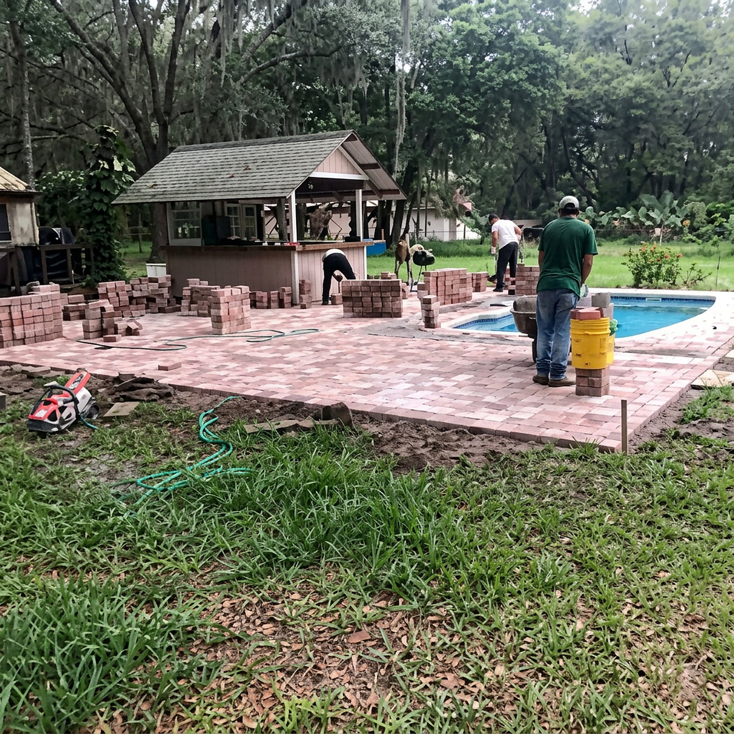 Paver pool deck construction with crew